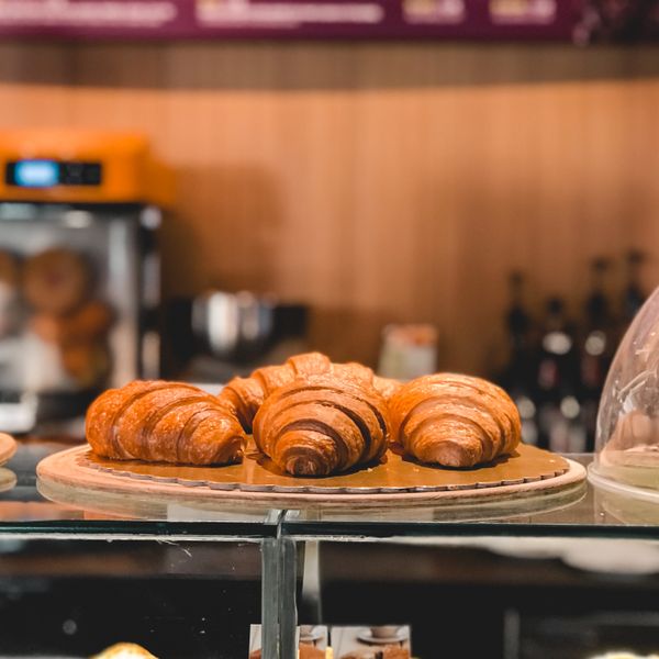 Croissants on the counter under the pastry dome